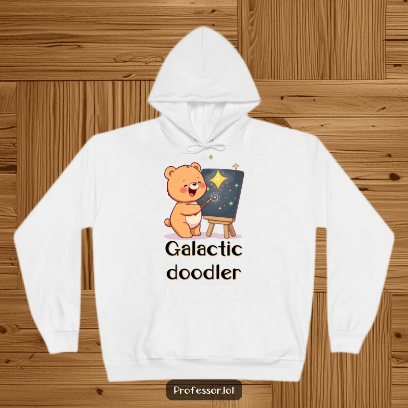 Funny hoodie with a content bear artist drawing a beautiful galaxy on a chalkboard, perfect for cozy nights.